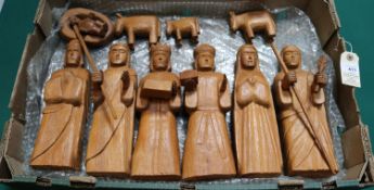 A wooden hand carved nativity set from Paraguay comprising of Jesus in a crib, Mary, Joseph, A
