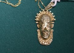 A 18K gold hallmarked chain, with a Tribal looking head pendant, also stamped 18K, very well cast.