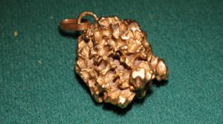 A gold nugget in natural form, has a ring attached for a chain. very unusual. Weight 12g.