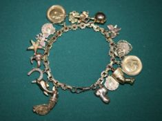 A Very impressive 9ct gold hallmarked charm bracelet with 16 charms, includes 2 shell charms with