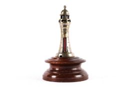 An unusual car mascot in the shape of a light house. Made by H.P. Rossi Engineering, Eastbourne. A