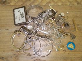 A box of assorted jewellery and a hallmarked silver photograph frame.