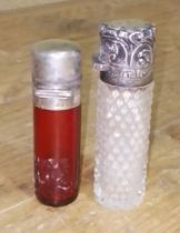 Two hallmarked silver mounted glass scent bottles.