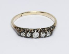 An antique five stone diamond ring, scroll setting, yellow metal band unmarked, gross weight 1.9g,