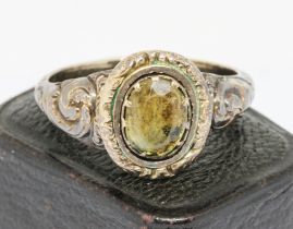 A Victorian yellow metal mourning ring set with green paste, inscribed with monogram and dated 1855,