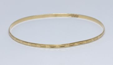 An eastern yellow metal bangle, marked '750' and also unascribed foreign mark, diameter