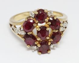 A hallmarked 9ct gold ruby and diamond cluster ring, the cluster measuring approximately 16mm in