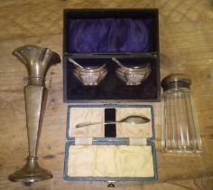 A mixed lot of hallmarked silver comprising a cased pair of salts, a vase, a cased spoon and a sugar