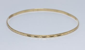 An eastern yellow metal bangle, marked '750' and also unascribed foreign mark, diameter