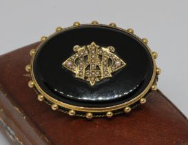 A Victorian split pearl and black onyx mourning brooch, yellow metal mount unmarked, 41mm x 31mm,