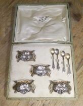 A cased set of French silver salts with glass liners and spoons.