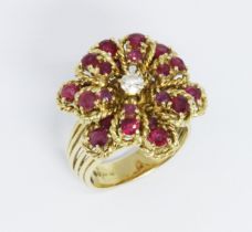 An 18ct gold diamond and ruby cluster ring, flower head cluster with central round brilliant cut