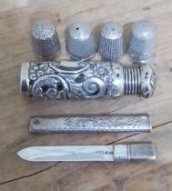 A mixed lot of hallmarked silver comprising four thimbles (including Charles Horner), a scent bottle