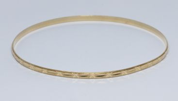 An eastern yellow metal bangle, marked '750' and also unascribed foreign mark, diameter