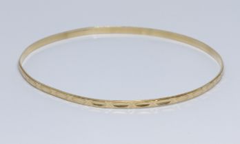 An eastern yellow metal bangle, marked '750' and also unascribed foreign mark, diameter