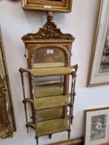 A 19th century French gilt framed pier mirror with three shelves, 103cm x 40cm (approx).
