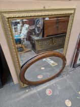 A large gilt framed mirror and a 1920s oak framed mirror.