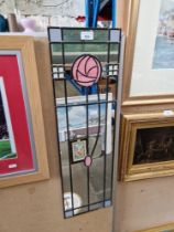 A leaded glass mirror in the style of Charles Rennie Mackintosh, 23cm x 76cm.
