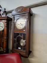 Early 20th century chiming wall clock with pendulum.