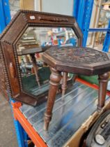 A 1920s oak framed mirror and a carved oak stool.