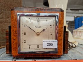 An Art Deco burr walnut and rosewood Ferranti electric mantel clock.
