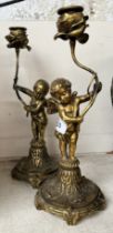 Pair of metal figure candlesticks