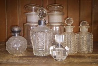 Various cut glass vintage perfume bottles to include with silver top.