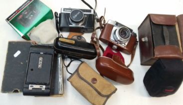 A box of old cameras to include Kodak, Brownie, Canon, etc.
