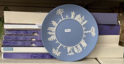 A collection of 12 boxed Wedgwood Christmas plates including 10 year anniversary plate and one other
