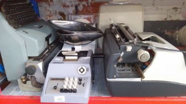 A mixed lot comprising vintage typewriters, Avery scales, and receipt machine.