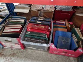 Three boxes of stamp albums containing world stamps.