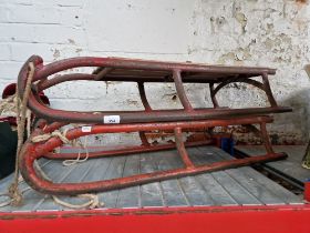 Two vintage sledges, wood seats and metal runners.