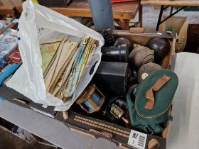 A box of various items including binoculars, bowls, sea fishing reel, a fly fishing reel and a bag