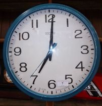 An Acctim circular enamelled wall clock.
