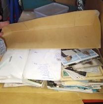 A box with collection of various stamps and a box of postcards.