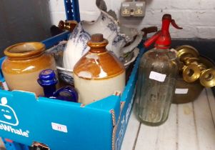 A mixed lot comprising a brass jam pan, a pair of brass candlesticks, stoneware flagons, wash jug
