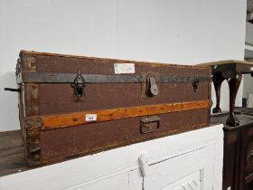 A vintage travel trunk with various old travel labels.