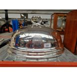 A large plated dish cover with crest.