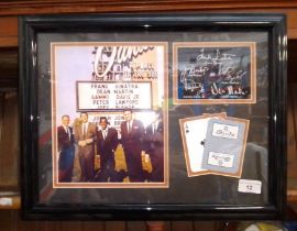 A Framed Rat Pack photo display with printed signatures and Sands Hotel playing cards.