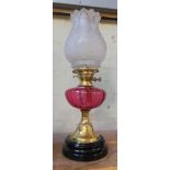 An Art Nouveau pink glass and brass oil lamp with frosted glass shade, height 57cm.