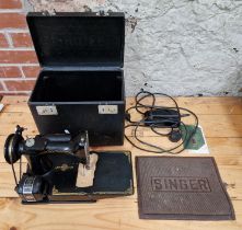 A Singer Featherweight 221K1 electric travel sewing machine with case.