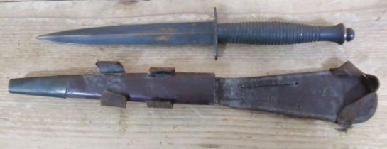 A Fairbairn Sykes fighting knife, unmarked blade, length 17.5cm, leather scabbard.