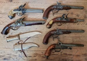 Six assorted replica flintlock pistols & an eastern dagger, one pistol marked 1804, Manufacture