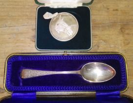 A hallmarked silver spoon and a hallmarked silver medallion "1st News of the World Grand National