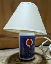 An original prop from the Peter Kay series 'Phoenix Nights', Kamikaze can table lamp, used in the