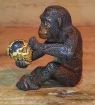A cold painted cast metal figure in the manner of Bergman, realistically modelled as a monkey