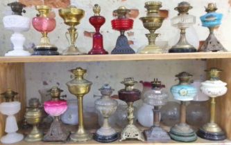 A group of 17 assorted oil lamps, various shades.