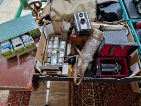A box of assorted cameras, accessories and 2 cases of various slides to include a Kodak....
