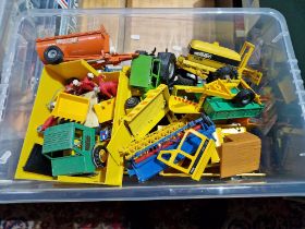 A Box of Britains die cast agricultural vehicles, accessories and figures.