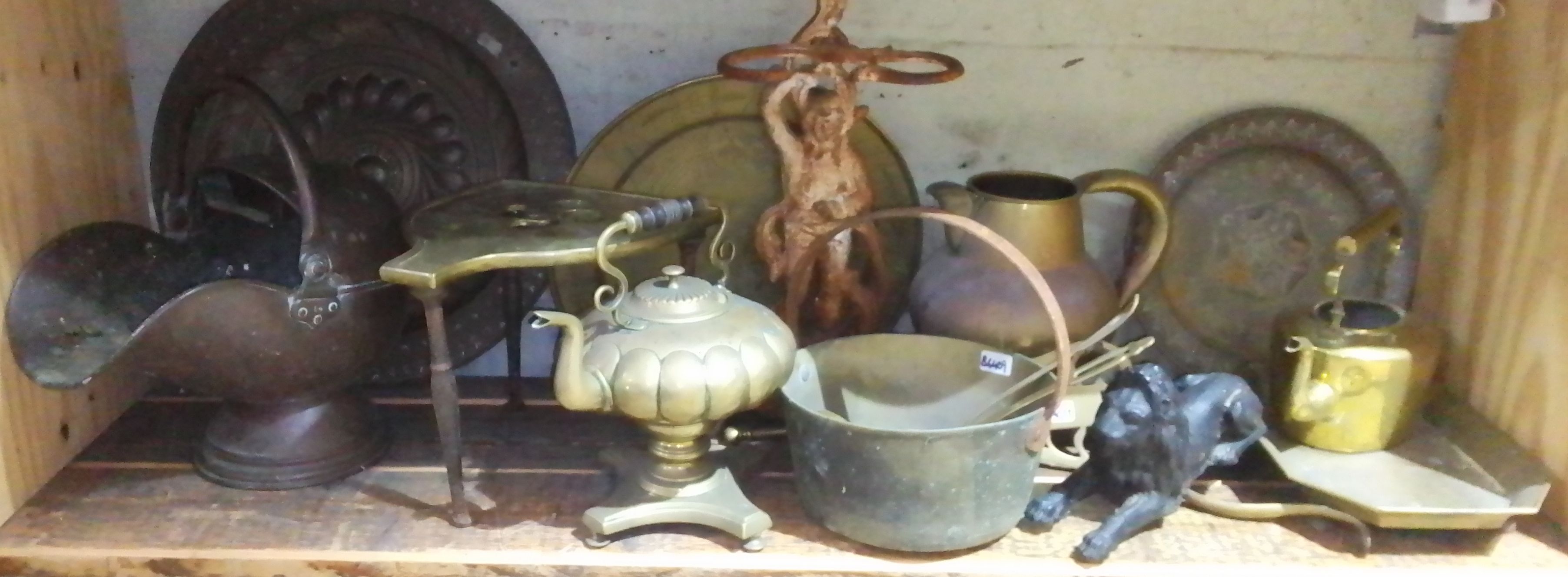 A quantity of assorted metal ware, brass, copper, a cast iron lion, chargers, trivet, etc. etc.